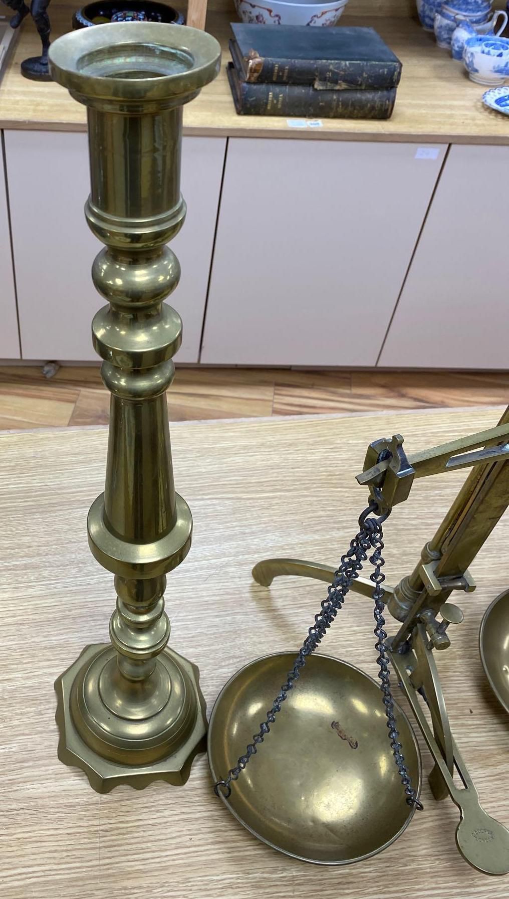 A pair of brass altar candlesticks, 60cm and a pair of Beam scales to weight 2lb, height 56cm